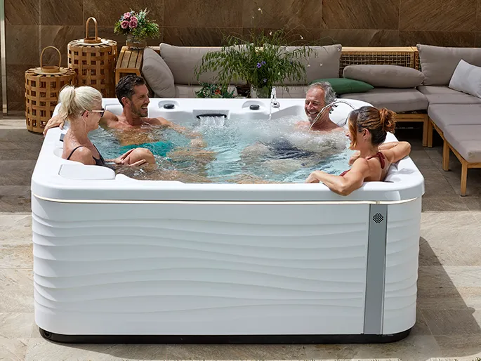 4 persons in a spa model essece with aurora furniture of the aquavia spa brand.