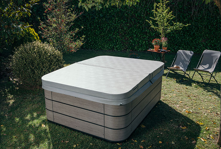 Aquavia hot tub cover in the garden of a residential house.